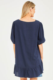 Model Kelly wearing size S of the Linen Blend Ruffle Hem Top in colour Navy (Blue), from the back