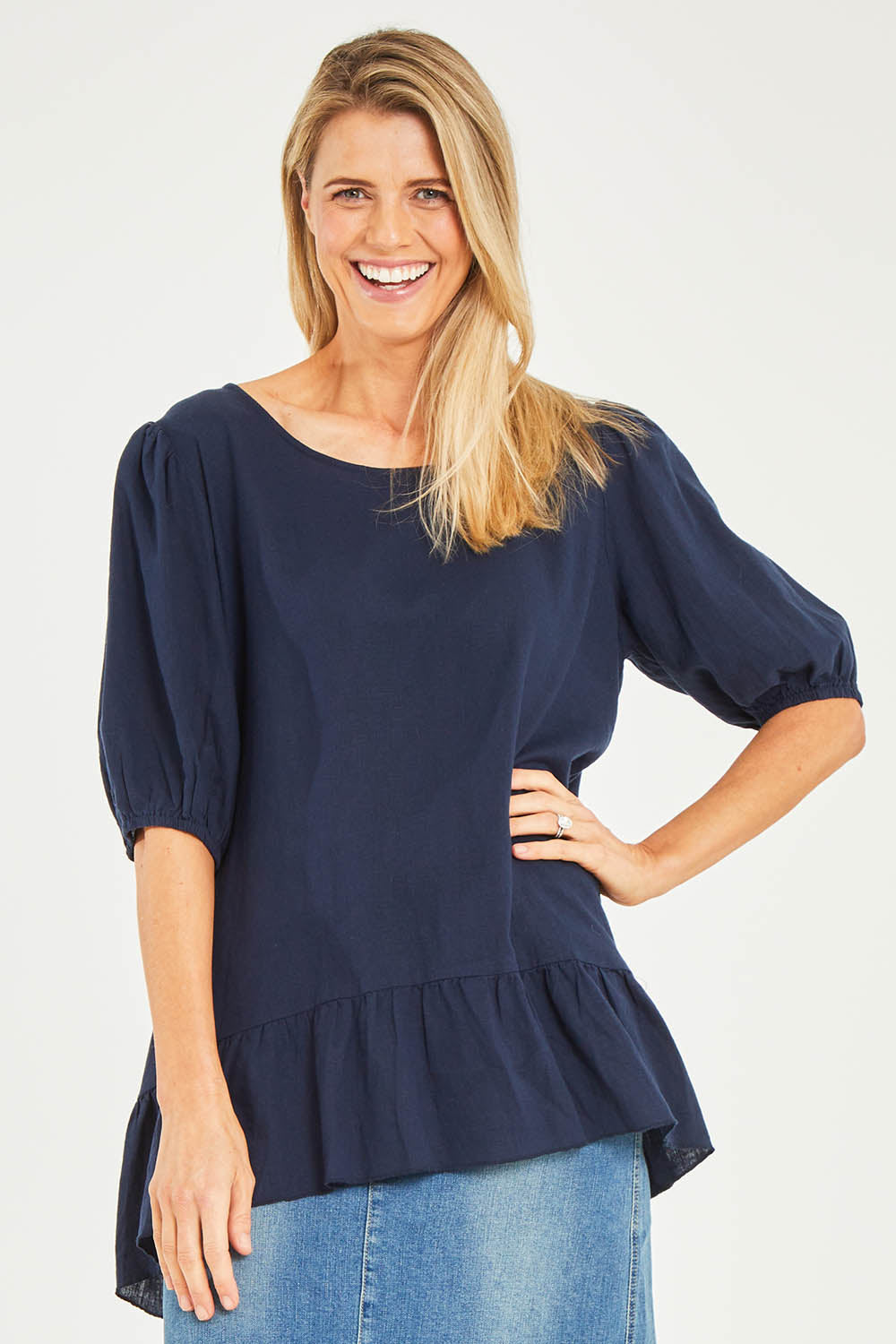 Model Kelly wearing size S of the Linen Blend Ruffle Hem Top in colour Navy (Blue), from the front, cropped image