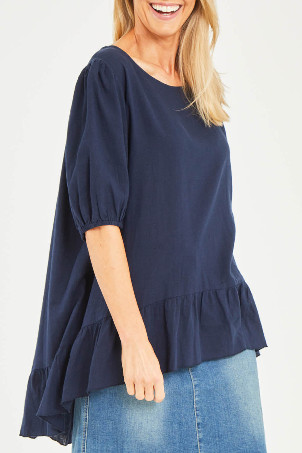 Model Kelly wearing size S of the Linen Blend Ruffle Hem Top in colour Navy (Blue), from the front, cropped image