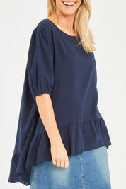 Model Kelly wearing size S of the Linen Blend Ruffle Hem Top in colour Navy (Blue), from the front, cropped image