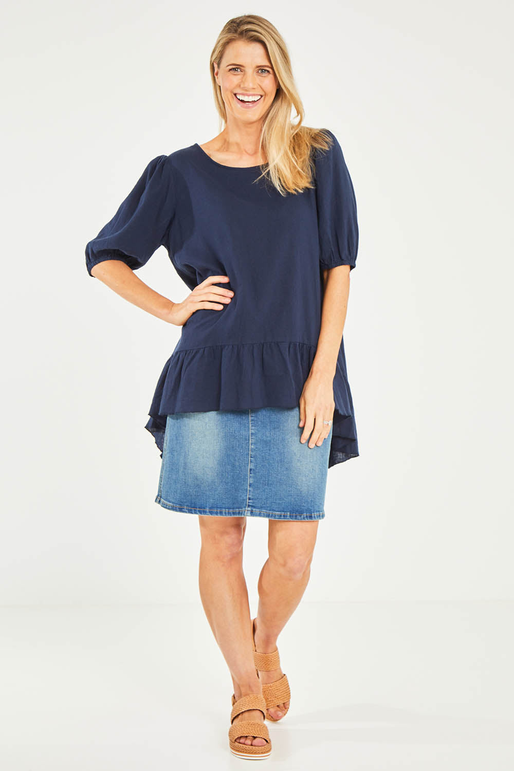 Model Kelly wearing size S of the Linen Blend Ruffle Hem Top in colour Navy (Blue), from the front, showing the whole outfit