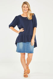 Model Kelly wearing size S of the Linen Blend Ruffle Hem Top in colour Navy (Blue), from the front, showing the whole outfit