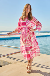 Model Katie wearing size S of the Cosmopolitan Dress in colour Pink (Pink), from the front, showing the whole outfit