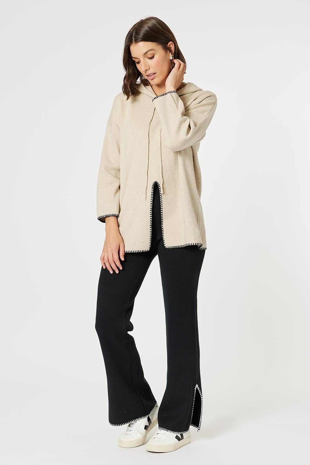 A model wearing the Cosy Knit Jumper in colour Natural, from the front, showing the whole outfit