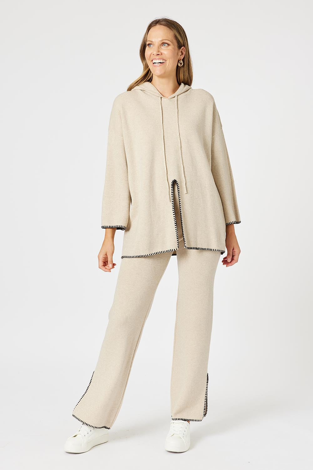 A model wearing the Cosy Knit Jumper in colour Natural, from the front, showing the whole outfit