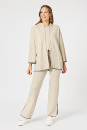 A model wearing the Cosy Knit Jumper in colour Natural, from the front, showing the whole outfit