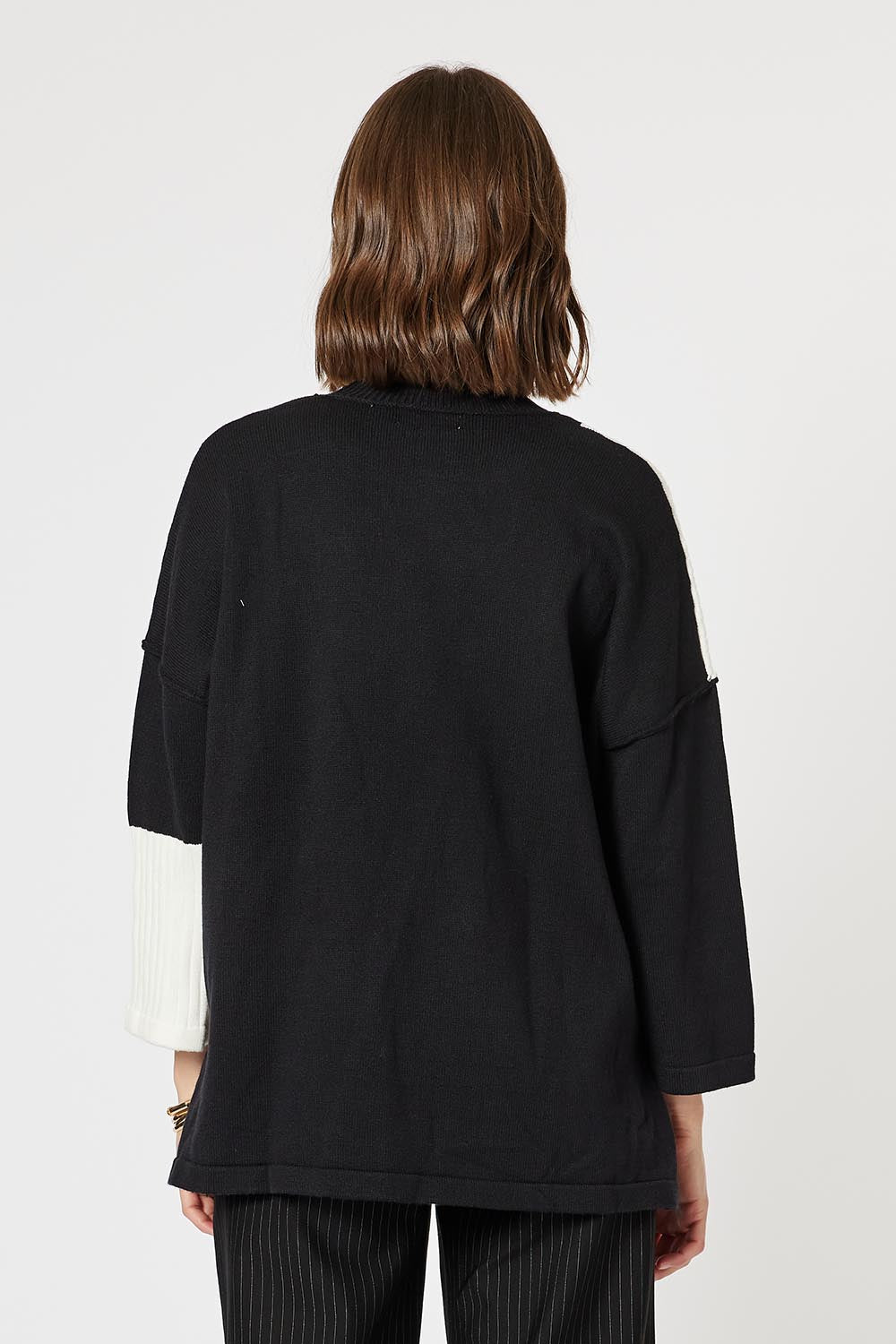 A model wearing the Mode Splice Knit Jumper in colour Black (Black), from the back