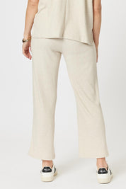 A model wearing the Lounge Pant in colour Natural, from the back