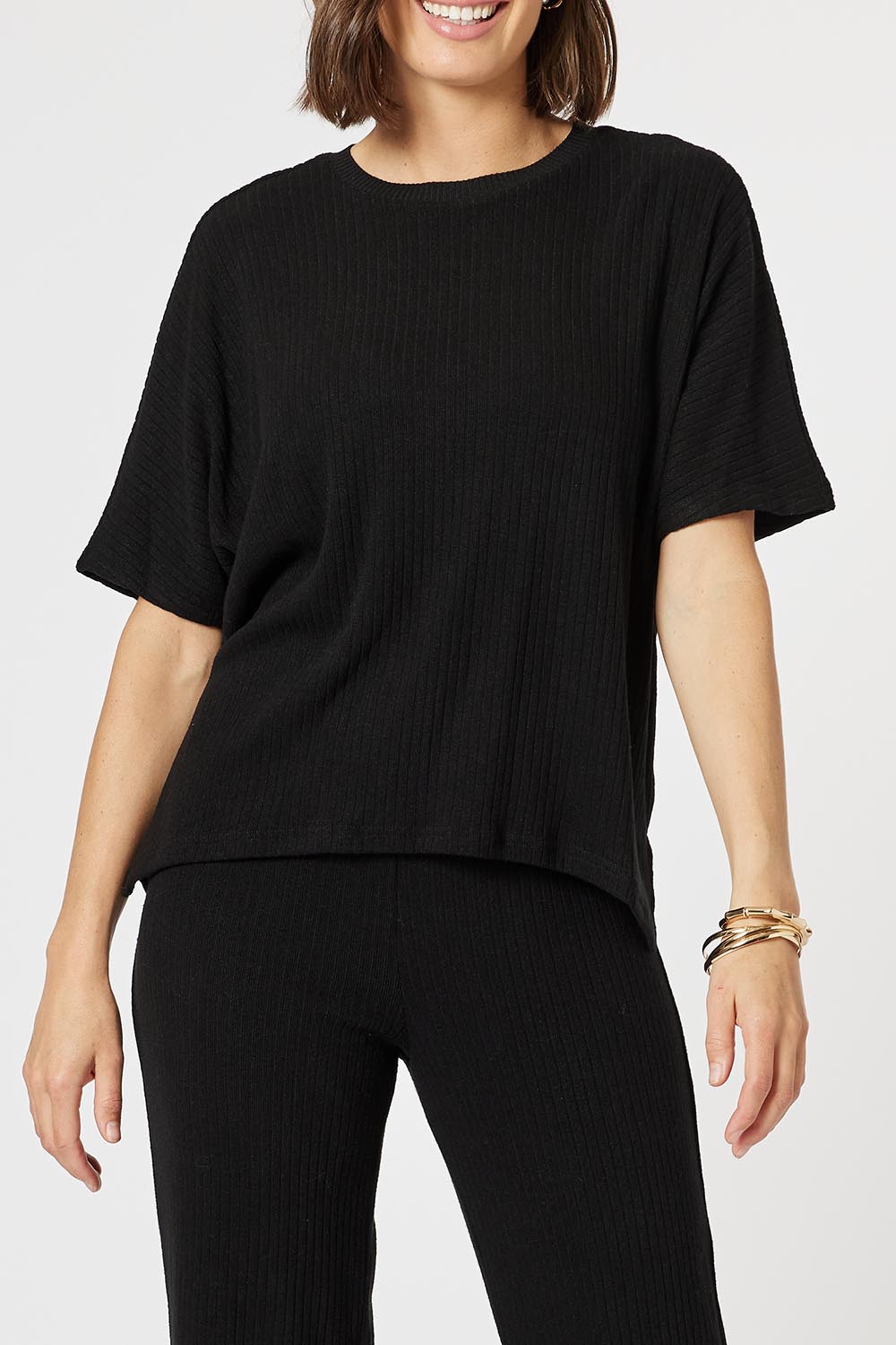 A model wearing the Lounge Top in colour Black (Black), from the front, cropped image