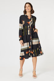 A model wearing the Galleria Dress in colour Black (Black), from the front, showing the whole outfit