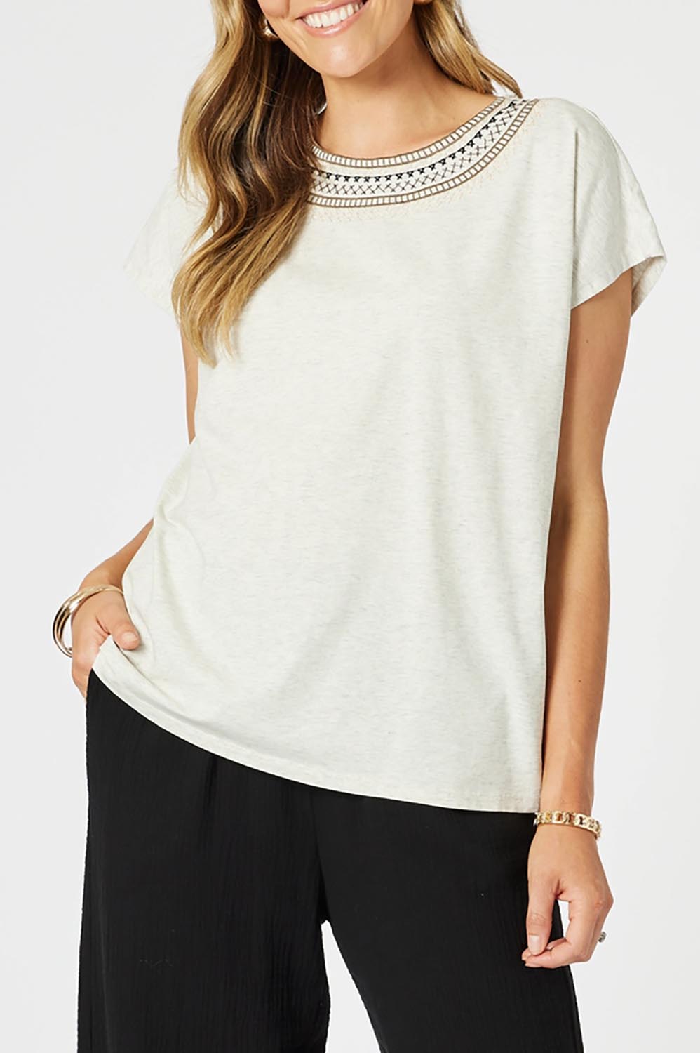 A model wearing the Cross Stitch Cotton Tee in colour Natural, from the front, cropped image