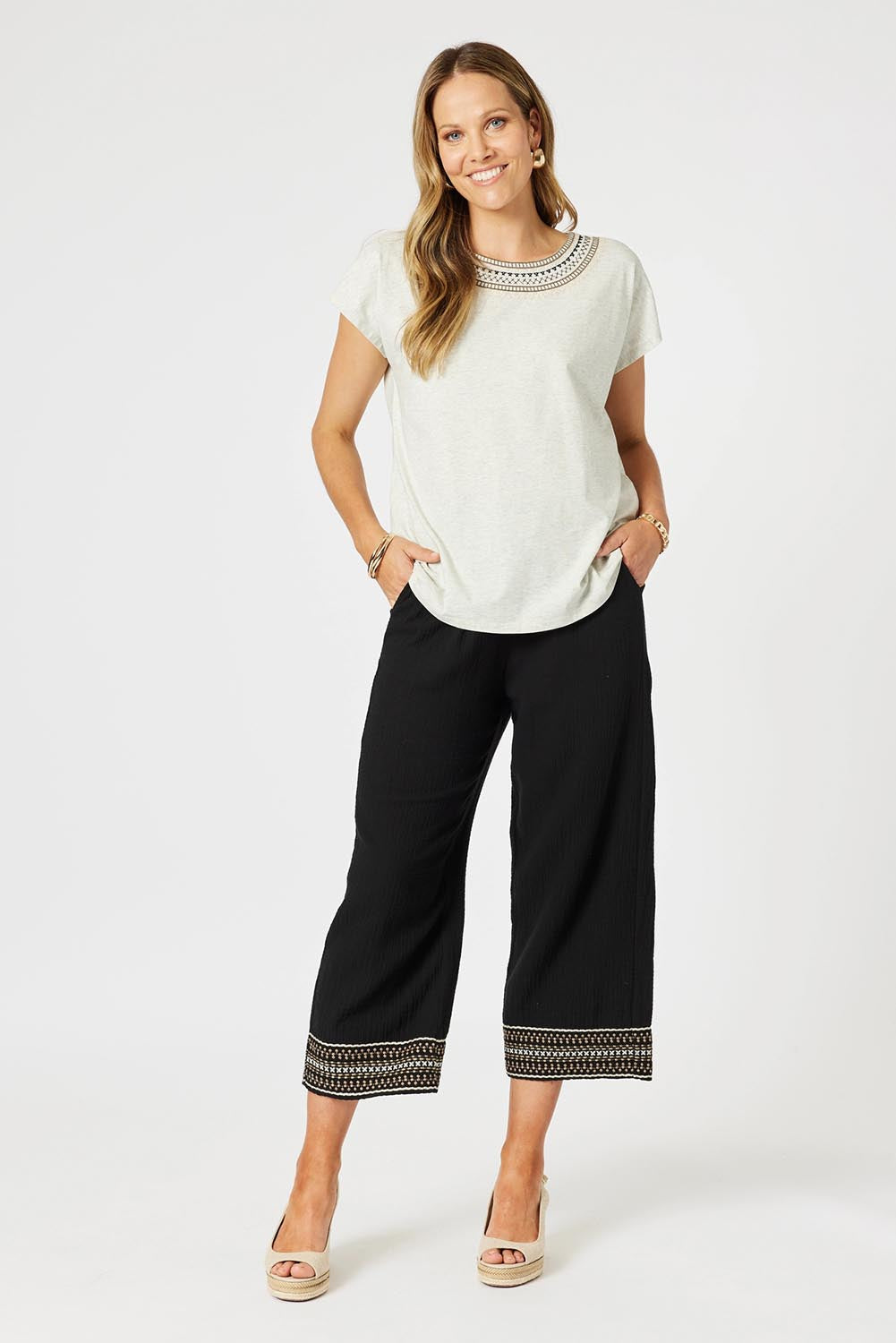 A model wearing the Cross Stitch Cotton Pant in colour Black (Black), from the front, showing the whole outfit