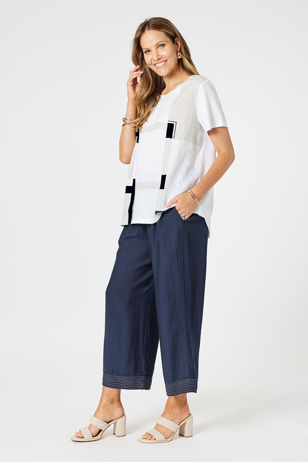 A model wearing the Geometric Linen Cotton Top in colour Navy (White), from the front, showing the whole outfit