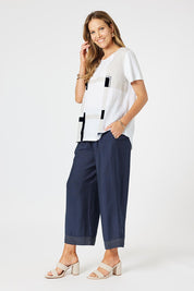 A model wearing the Geometric Linen Cotton Top in colour Navy (White), from the front, showing the whole outfit