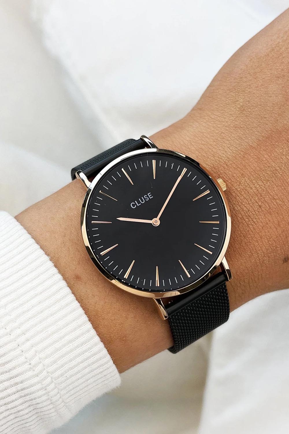 A model wearing the Chic Black Rose Gold Watch in colour Blackrose (Black), from the front, cropped image