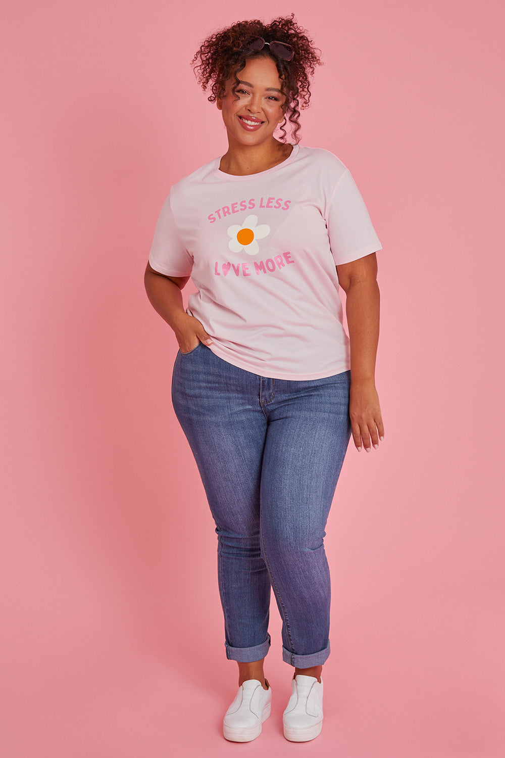 Model Alexis wearing size XXL of the Stress Less Love More Tee in colour Pink (Pink), from the front, showing the whole outfit