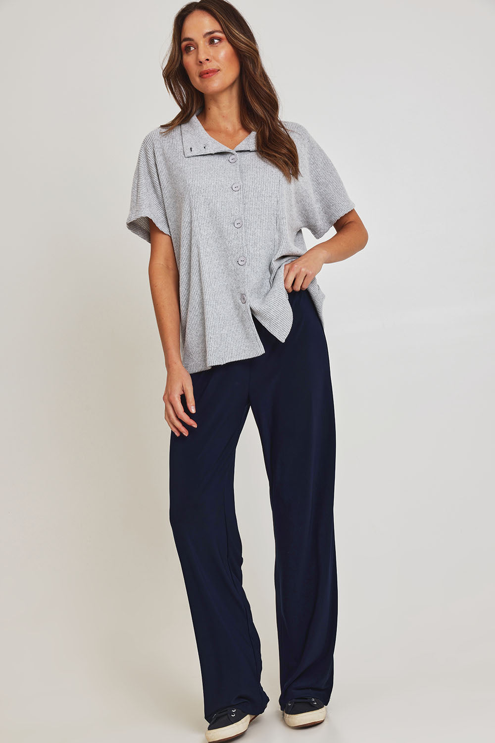 Model Madeline wearing size 10 of the Travel Wide Leg Pant in colour Navy (Blue), from the front, showing the whole outfit