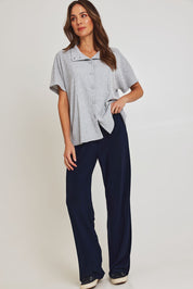 Model Madeline wearing size 10 of the Travel Wide Leg Pant in colour Navy (Blue), from the front, showing the whole outfit