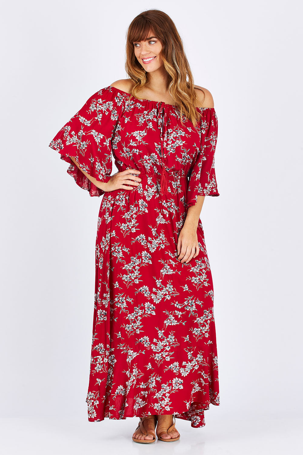 Model Laura wearing size 12 of the Floral Off The Shoulder Dress in colour Red (Red), from the front, showing the whole outfit