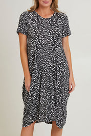 Model Grace wearing size 10 of the Cap Sleeve Bounce Dress in colour Blkwhite (Black), from the front, cropped image