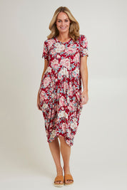Model Grace wearing size 10 of the Cap Sleeve Bounce Dress in colour Cherry (Red), from the front, showing the whole outfit
