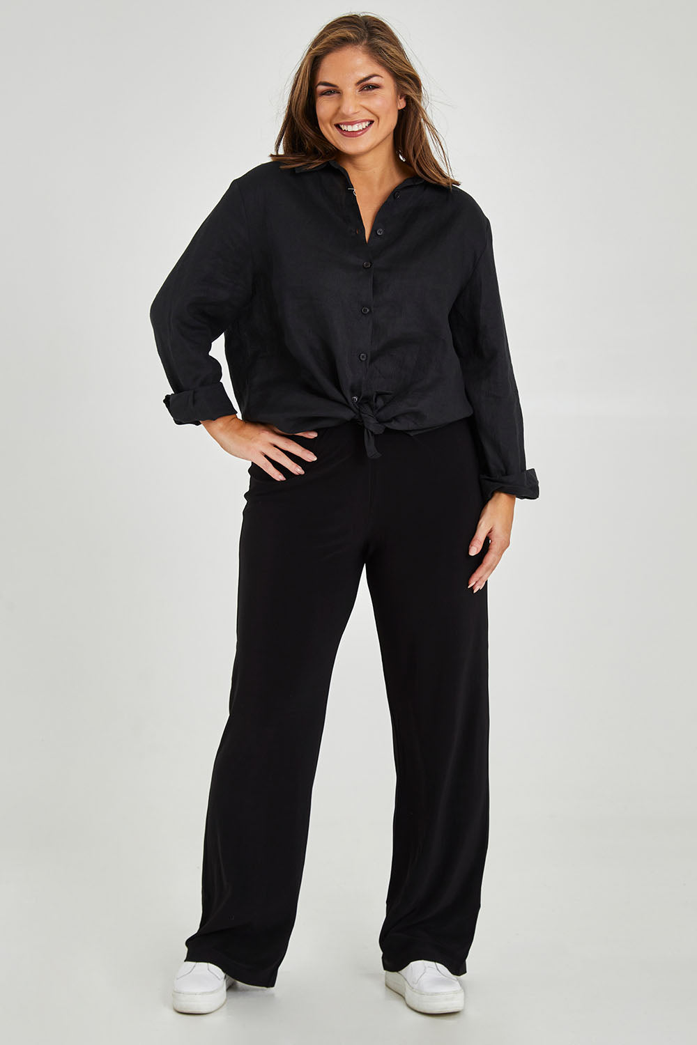 Model Monique wearing size 14 of the Classic Travel Pant in colour Black (Black), from the front, showing the whole outfit