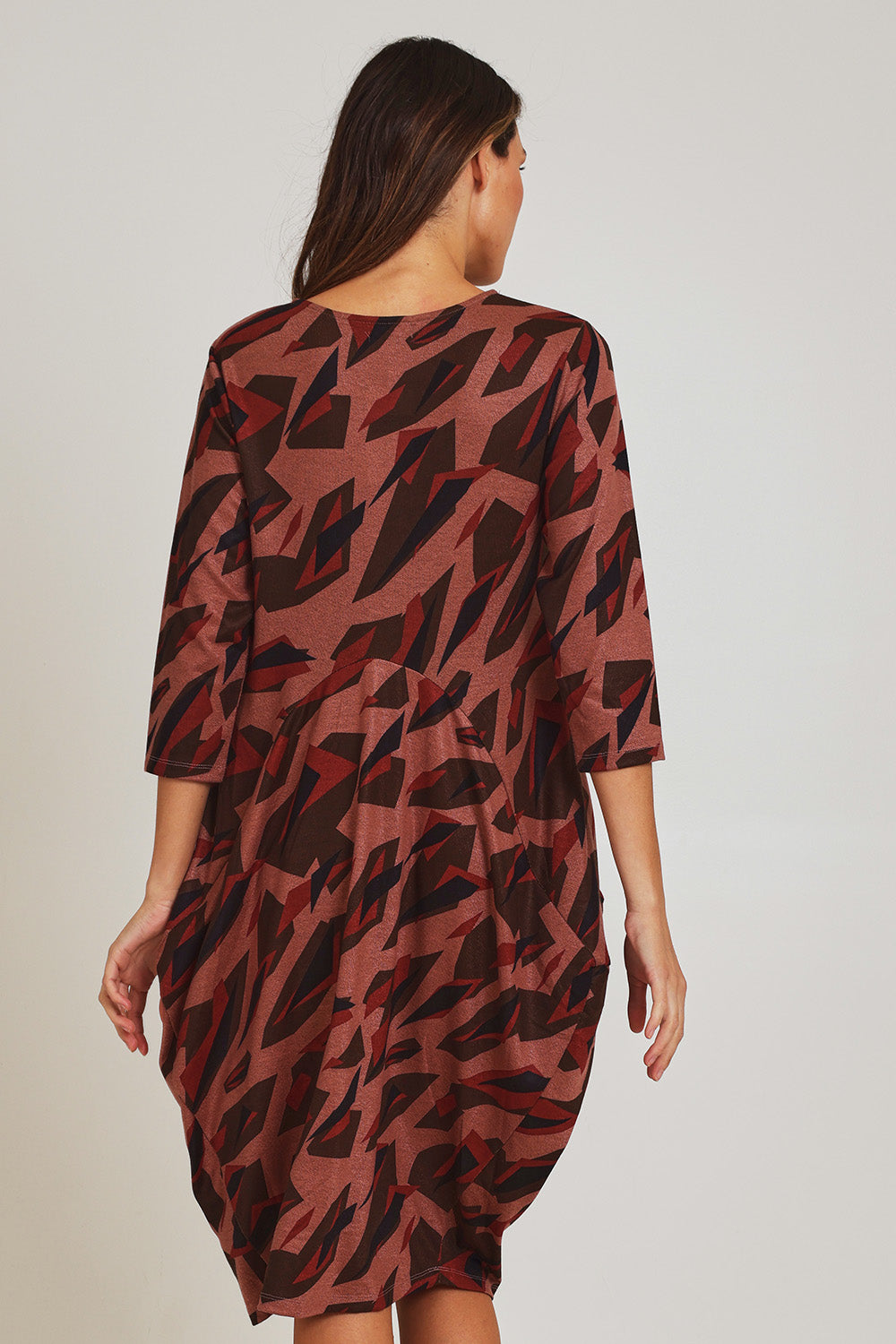 Model Madeline wearing size 10 of the Bounce Dress in colour Pinkred (Pink), from the back
