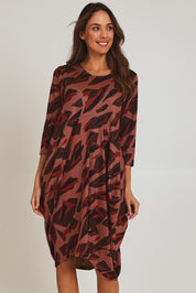 Model Madeline wearing size 10 of the Bounce Dress in colour Pinkred (Pink), from the front, cropped image