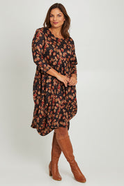 Model Monique wearing size 14 of the Bounce Dress in colour Rust (Black), from the front, showing the whole outfit