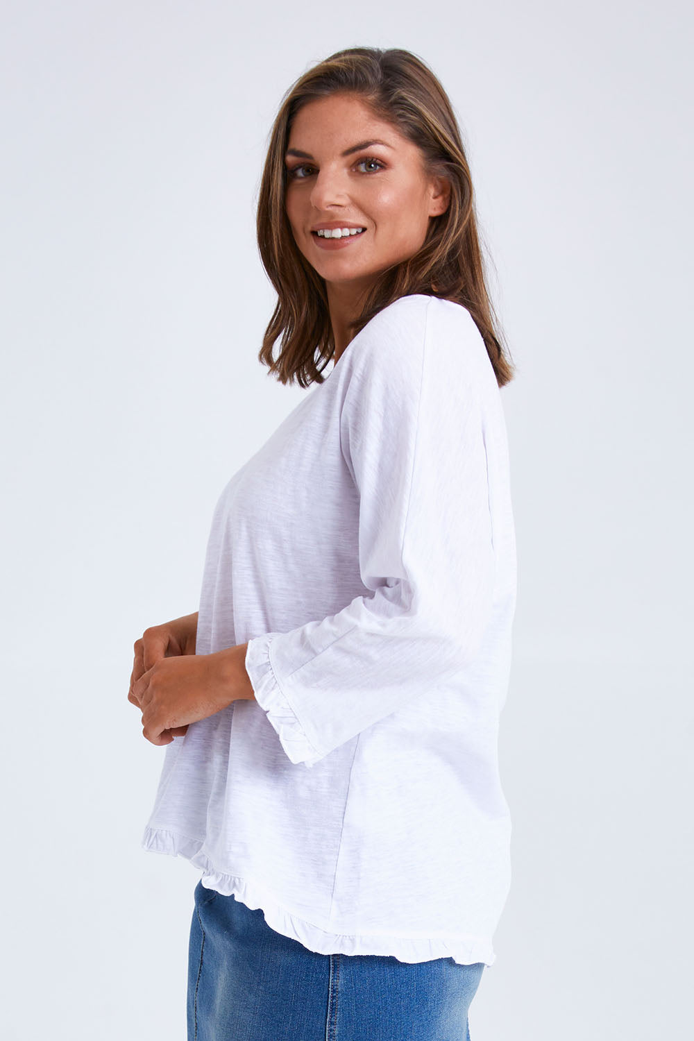 Model Monique wearing size 14 of the Ruffle 3/4 Sleeve Top in colour White (White), from the front, cropped image