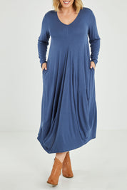 Model Jess wearing size 14 of the Jo Jo Core Dress in colour Petrol (Blue), from the front, cropped image