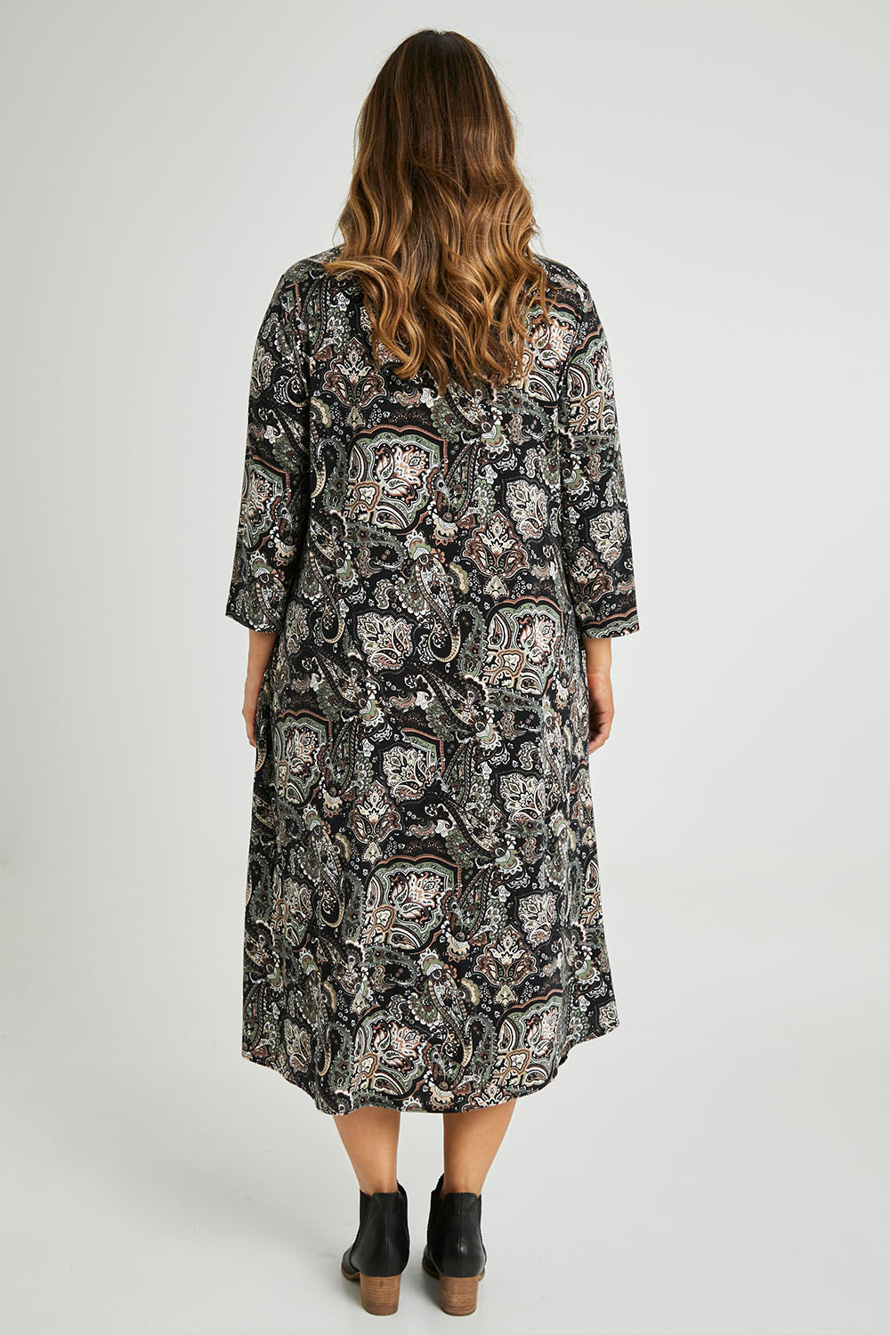 Model Laura wearing size 14 of the Jo Jo Print Jersey Dress in colour Green (Green), from the back