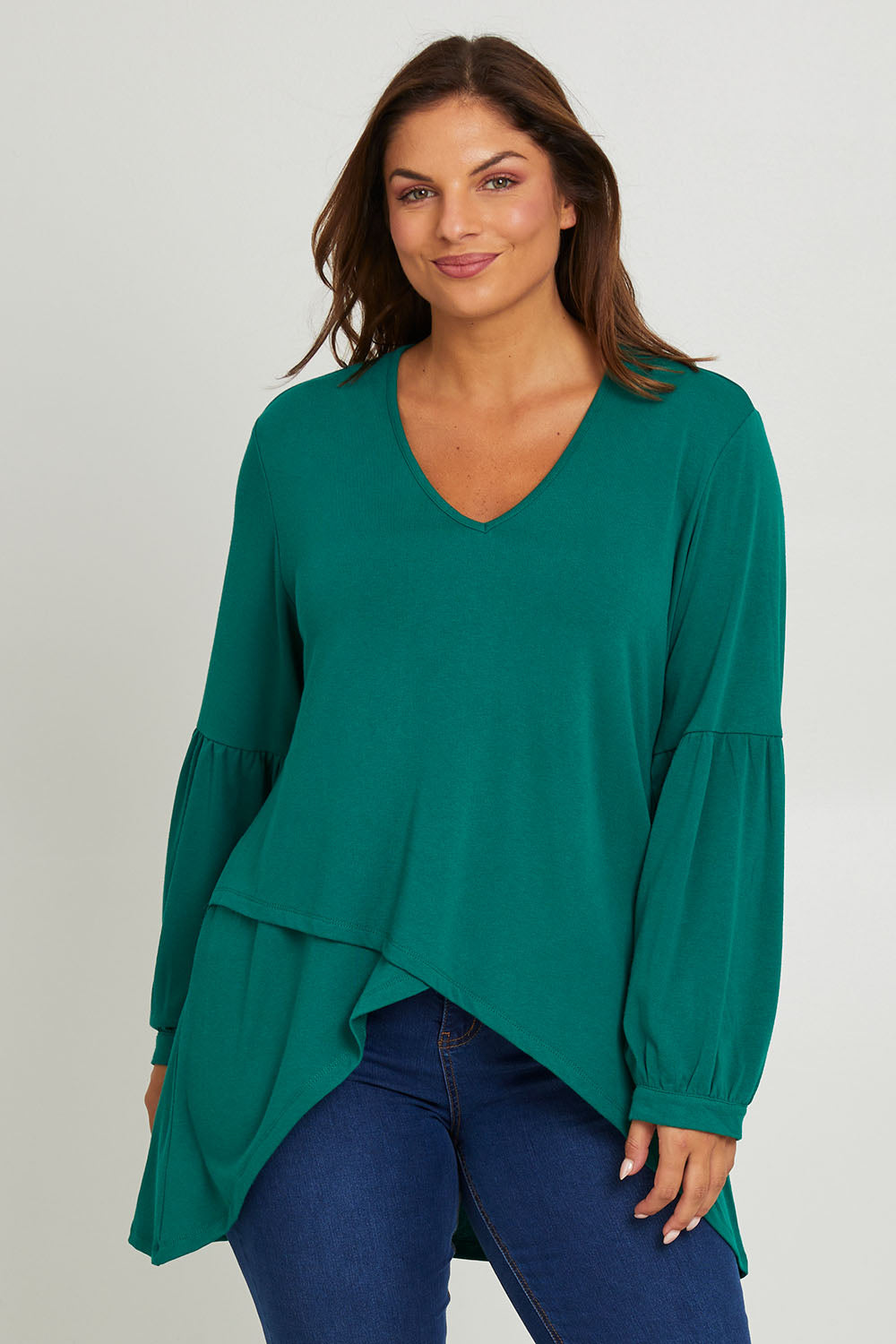 Model Monique wearing size 14 of the Hi Lo Knit Tunic in colour Forest (Green), from the front, cropped image