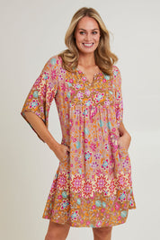 Model Grace wearing size 10 of the Sun Dress in colour Floral, from the front, cropped image