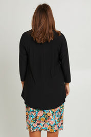 Model Monique wearing size 14 of the Forgiveness Long Dress in colour Blkfloral (Black), from the back