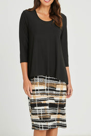 Model Madeline wearing size 10 of the Forgiveness Long Dress in colour Camelblk (Black), from the front, cropped image