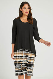 Model Madeline wearing size 10 of the Forgiveness Long Dress in colour Camelblk (Black), from the front, cropped image