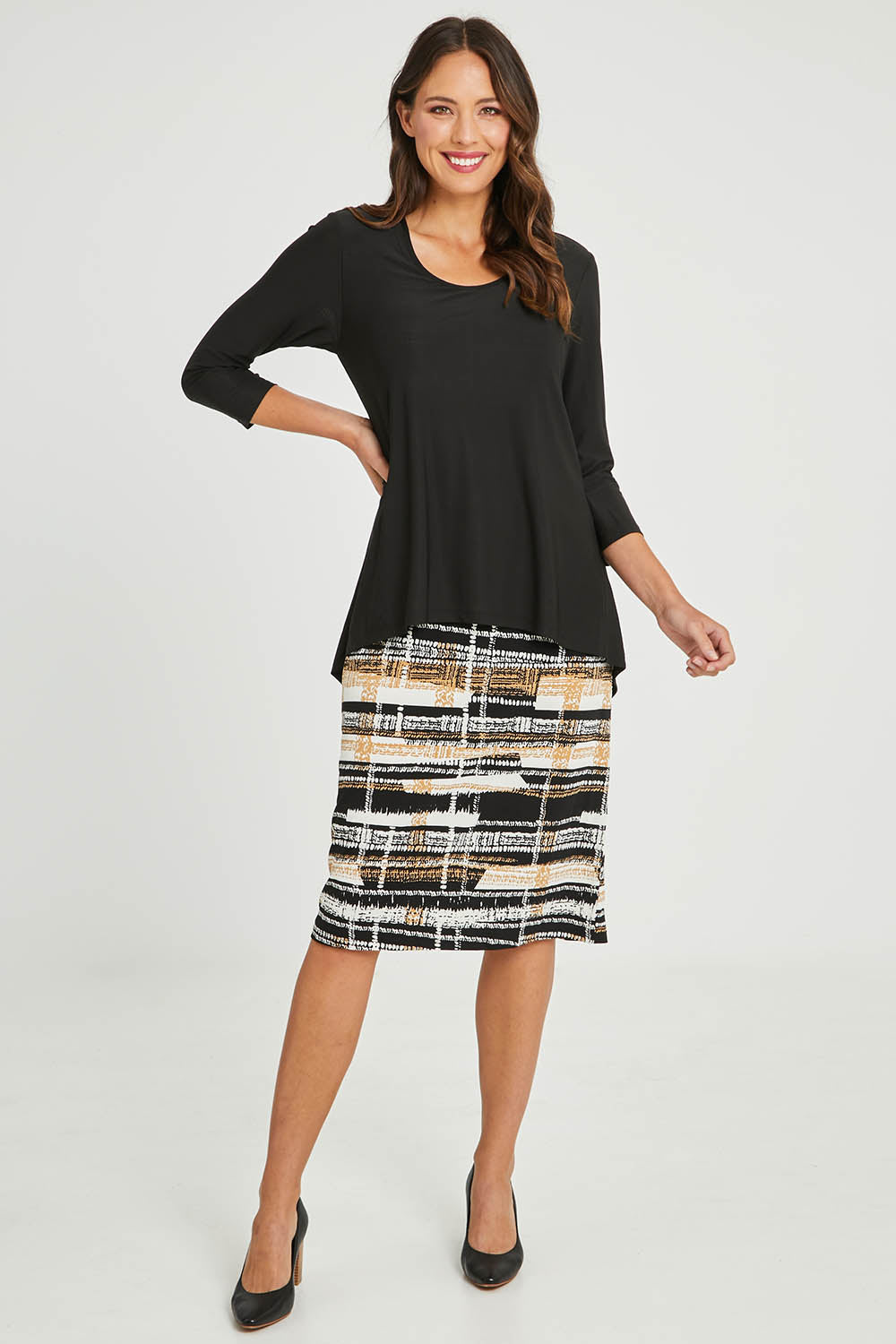 Model Madeline wearing size 10 of the Forgiveness Long Dress in colour Camelblk (Black), from the front, showing the whole outfit