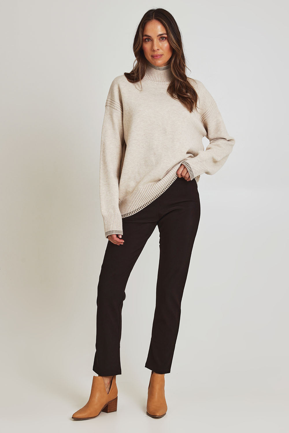 Model Madeline wearing size 10 of the Pencil Pant in colour Mocha, from the front, showing the whole outfit