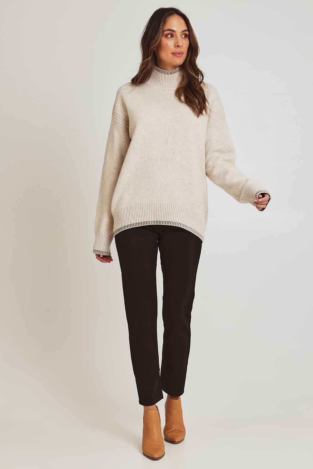 Model Madeline wearing size 10 of the Pencil Pant in colour Mocha, from the front, showing the whole outfit