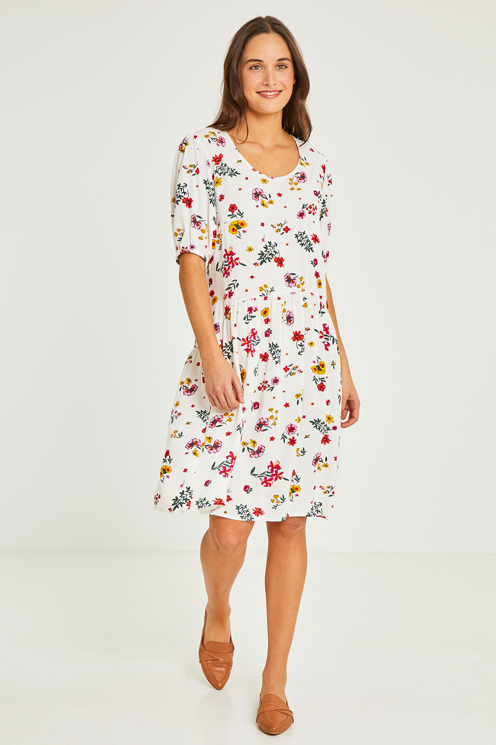 Model Elhana wearing size 10 of the Paradise Print Tunic Dress in colour Print (White), from the front, showing the whole outfit