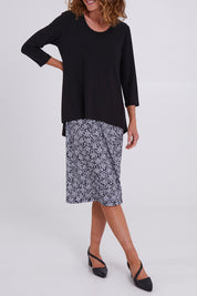 Model Emma wearing size 10 of the Ditsy Delight Forgiveness in colour Blkwhite (Blue), from the front, cropped image