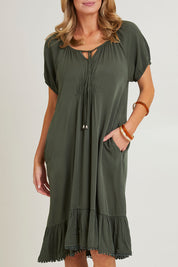 Model Grace wearing size 10 of the Lucy Core Dress in colour Khaki (Green), from the front, cropped image