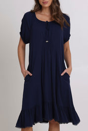 Model Madeline wearing size 10 of the Lucy Core Dress in colour Navy (Blue), from the front, cropped image