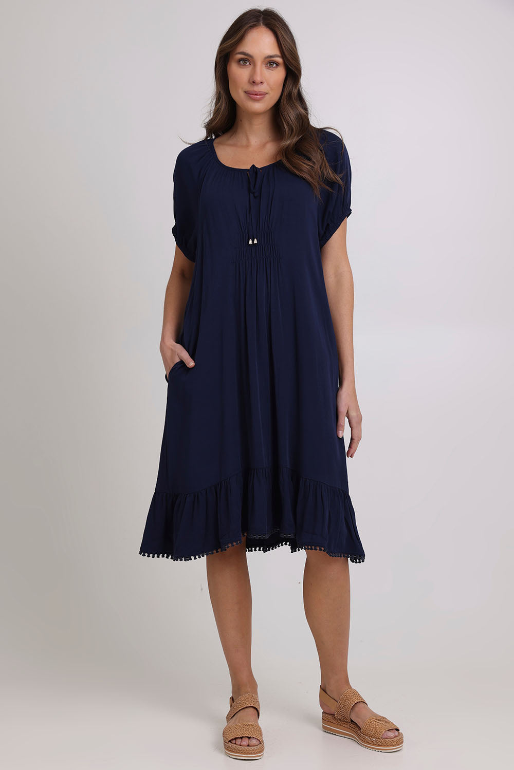 Model Madeline wearing size 10 of the Lucy Core Dress in colour Navy (Blue), from the front, showing the whole outfit