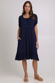 Model Madeline wearing size 10 of the Lucy Core Dress in colour Navy (Blue), from the front, showing the whole outfit