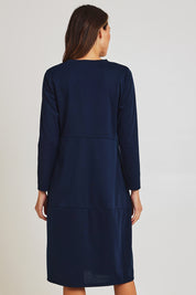 Model Madeline wearing size 10 of the Core Pocket Dress in colour Navy (Blue), from the back