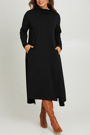 Model Monique wearing size 14 of the Margie Cowl Pocket Cotton Blend Dress in colour Black (Black), from the front, cropped image