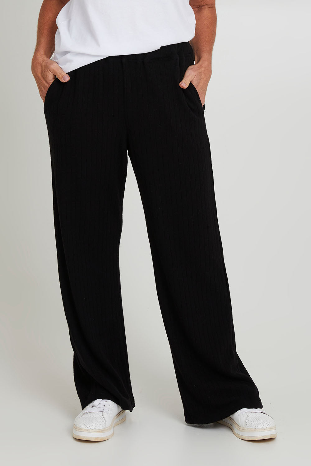 Model Sandy wearing size 10 of the Rachel Rib Pant in colour Black (Black), from the front, cropped image