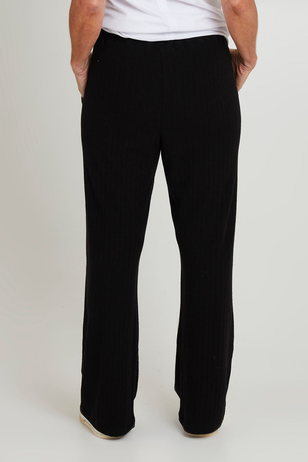 Model Sandy wearing size 10 of the Rachel Rib Pant in colour Black (Black), from the front, cropped image